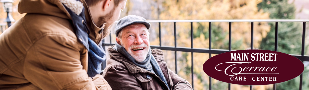 man smile at grandson outside on patio