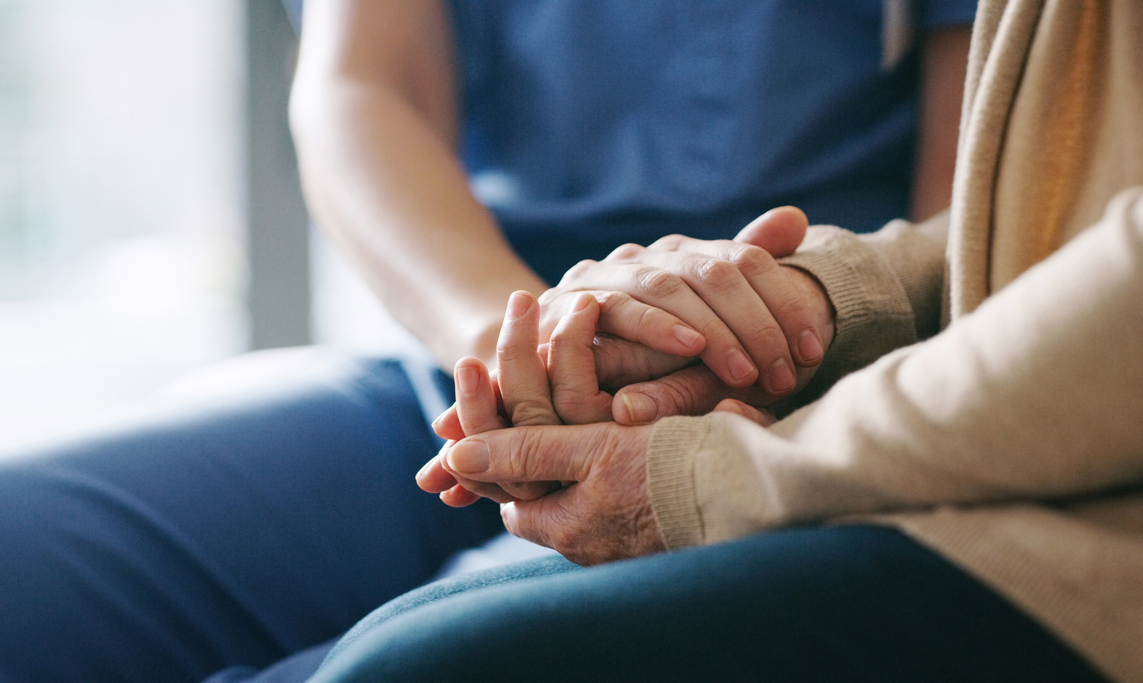 Holding-Hands nurse holding hands of olders women